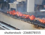Street food of Asia: barbecue chicken tikka on the local food street of Burns Road. Grilled chicken Chargha chicken on skewers