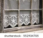 A Lace Curtain Adorns An Old...