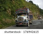 Small photo of BHUTAN - SEPTEMBER 28: Trucks on the road on September 28, 2013, Bhutan. The mountains make impossible to use rail in Bhutan, so traffic is exclusively by road. Trucks are used for carrying stuff.