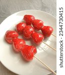 Small photo of Tanghulu Strawberry candied coated in clear and crispy sugar glaze, Tang dun er coated in a hardened sugar syrup