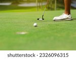 Small photo of Golfers putting golf balls on the green amid the warm sunshine in the morning. Concept of Outdoor activities and Outdoor sports, Concept of Golfer and Lifestyle.