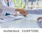 Small photo of Doctor shook hands with the patient after informing the results of the examination and informing the patients about treatment guidelines and prescribing medicines. Disease examination concept.