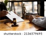 Small photo of The lawyer explains the contract before allowing the client to sign the lawsuit admitting that the defendant is a business partner who has opened a company and has cheated. Asset embezzlement concept.