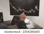 Small photo of Person looking at stock chart, businessman stock investor trading stocks, stock market analysis for profitable trading, investing in cryptocurrencies. Concept of investing in stocks.
