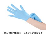 Individual protection products vinyl disposable gloves in the spread of virus and protection against infections. Women is dressing her hands in gloves. The coronavirus protection trend is COVID-19.