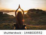 Small photo of Young woman practicing yoga outdoors. Spiritual harmony, introspection and well-being concept. Landscape background