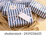 Wedding favours nautical style decoration soap guest gifts, wrapped in blue white striped pattern paper, cotton ribbon, custom label, sailor rope background, original summer beach party souvenir