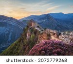 Amazing sunrise at the ancient fortress on the top of the mountain. The Gunib fortress is a historical monument of Dagestan. Russia. 