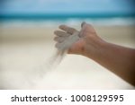 Let it go, Freedom hand , and Release concept. Hand let go of woman release sand on beautiful sea beach and blue water background