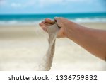 Small photo of Freedom,Let it go and Release concept.Freedom Hand of woman release sand on beautiful seabeach and blue water background.