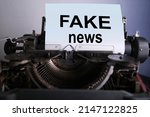 Small photo of fake news typed on old typewriter, blank white sheet for text, concept of works of dishonest journalism, deception, Fake concepts, staging to discredit information, retro technologies, news