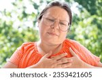 Small photo of woman 40-45 years old holds on to heart, sudden chest pain, close up female face with facial expression suffering, Ischemic heart disease, Arterial hypertension, Myocarditis or Arrhythmia