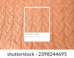 Small photo of beautiful Peach Fuzz Pantone Color year 2024 knitted braid pattern of light brown wool yarn, knitted texture, fashion trend palette, Frankfurt - December 7, 2023