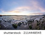 Small photo of Panoramic View of Rocky shore at Seawall in Downtown Vancouver, British Columbia, Canada. Colorful Winter Sunset. Modern City on the Pacific Ocean West Coast.