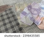 Small photo of Subang, Indonesia - December 4, 2023 : Indonesian currency denomination Rp. 10,000 rupiah, Rp. 2,000 rupiah and Rp.5,000 rupiah
