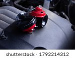 Red air horn for a car on a car engine. Electric Car air horn.