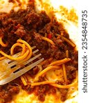 Small photo of Close-up Photo of a Half-Eaten Saucy Spaghetti | Pasta with Meat, Sauce with Chopped Spices