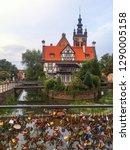 Small photo of GDANSK, POLAND - SEPTEMBER 2, 2018: View of many love locks at the Love Bridge and Miller's House at the Mill Island in Gdansk's Old Town in Poland. St. Cathrine's Church is in the background.
