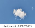 Small photo of a small cloud flouting in the blue sky.