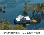 Small photo of Surrounded by hurricane Ian rainfall flood waters home in Florida residential area. Consequences of natural disaster