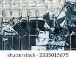Broken down photovoltaic solar panels destroyed by hurricane Ian winds mounted on industrial building roof for producing green ecological electricity. Consequences of natural disaster