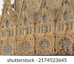 Small photo of BARCELONA, SPAIN, SEPTEMBER 30, 2021, Detail with rosette windows and sculptures of the Nativity facade, architecture detail of Sagrada Familia bascilica by Antonia Gaudi, Barcelona, 30 September 2021