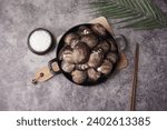 Small photo of Large and delicious live Korean cockles against a gray background