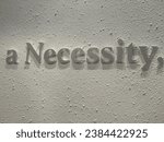 the words a necessity on the wall
