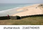 Small photo of An individual cyclist has dismounted at the Phare de Carteret Lighthouse and is looking north towards Flamanville, Barneville-Carteret, Manche, Normandy, France, Europe on Tuesday, 10th, May, 2022