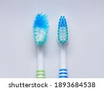 Small photo of Comparison of the old and new toothbrushes in macro view, showing different bristle conditions: time to change a new toothbrush