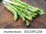 Small photo of Asparagus. Raw green asparagus ( sparrow grass) on wooden background