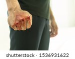 Aggressive violent man in a fight, with a bloody fist.