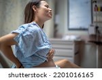 A woman in labor having contractions in the hospital delivery room. Childbirth and pregnancy.