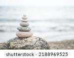 Pebble tower balance harmony stones arrangement on sea beach coastline. Relaxing peaceful formation pyramid cobblestone philosophy equilibrium spiritual tranquility. Spa therapy summer travel vacation
