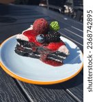 Small photo of Cake slice, mulberry, bayberry, blueberry on top