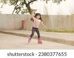Small photo of Bandung, The park (Pasar Kreatif Jawa Barat) Indonesia - Mei 18, 2023 : little girl practicing inline skate on the street