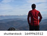 Small photo of Lonely mountaineer get rest on snowy mountain high above the clouds into the sun