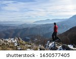 Small photo of Happy mountaineer get rest and enjoy on snowy mountain high above the clouds. Look into the sun and snow