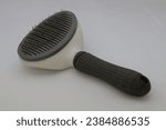 Small photo of A brush for cat and dog, slicker brush is perfect for this as they have short metal bristles that slide over fur and smooth out any knots