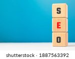 Small photo of Text SEO on wood cubes. Abbreviature of 'Search Engine Optimization'. Website traffic concept.