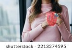 Small photo of Woman having clutching chest with heart anatomy, heart attack, heart disease, Female with health care and Healthy feminine, World Heart Day concept.
