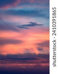 Small photo of A fiery and cloudy sunset sky. A clash of colors and light. The colors of the sky are in a constant state of flux, as the sun sets and the clouds move. This creates a sense of dynamism and excitement
