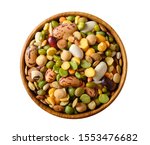 Various dried legumes: lentils bean pea chickpea in a wooden cup top view isolated on white.