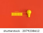 Light bulb and loading on red background. Inspiration and creative idea concept.