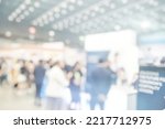 Small photo of Blur background consultant helping parentsstudents with educational planning in education fair. Blurry booths of school or company for people to find school or job in career expo in lobby hall.