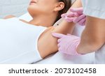 Small photo of The doctor makes injections of botulinum toxin in the underarm area against hyperhidrosis. Women's cosmetology concept.