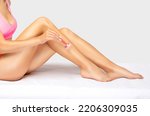 The girl shaves her legs.hair removal procedure on a woman’s body. Removing unwanted body hair. 