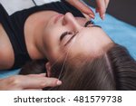 Master corrects makeup, gives shape and thread plucks eyebrows in a beauty salon. Professional care for face.