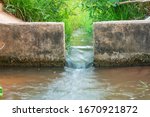 Water flows through the floodgate in the irrigation canal quickly.Water management, irrigation system, irrigation dam, irrigation canal To send to agricultural plots. To solve drought in northeast
