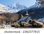 Small photo of Les Praz de Chamonix medieval church and Aiguille Dru mountain on the background, Tour du Mont Blanc, Alps, France